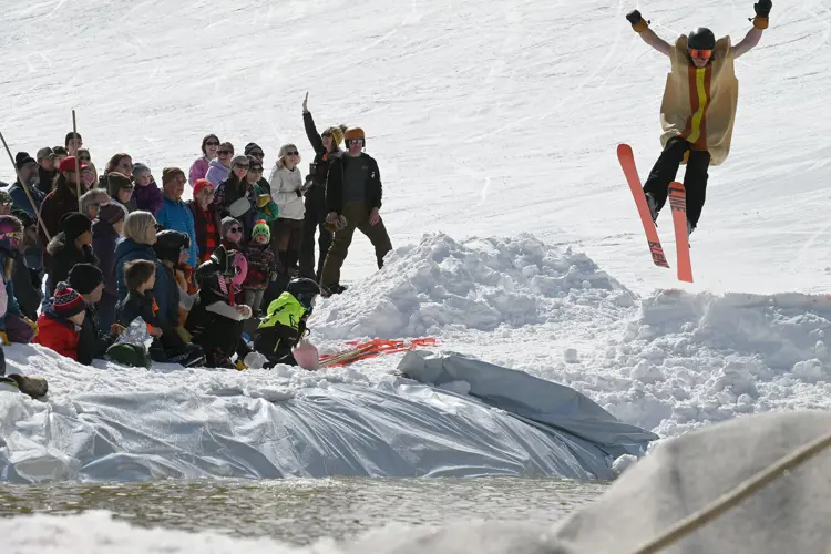Skiier wearing a hot dog costume during the slush cup